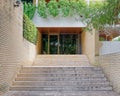 Contemporary residential apartment building entrance stairs and light brown brick walls