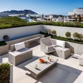 A contemporary rooftop terrace with comfortable outdoor seating, a built-in barbecue grill, and breathtaking views of the ocean1 Royalty Free Stock Photo