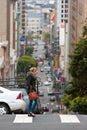 Contemporary Scene Of San Francisco As Woman Crosses Hilly Street