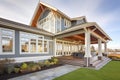 contemporary shingle style house with fulllength windows, sea