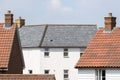 Contemporary suburban housing estate. Modern white house with slate roof tiles Royalty Free Stock Photo