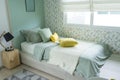 Contemporary teen bedroom with green pillow