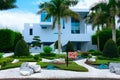 Contemporary tropical mansion house with palm trees and zen garden with FOR SALE sign in the front yard Royalty Free Stock Photo