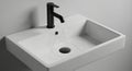 Sleek Wall-Mounted Rectangular White Basin with Elegant Matte Black Faucet in Modern Minimalist Bathroom Royalty Free Stock Photo
