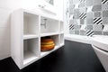 Contemporary white painted MDF bathroom unit, with colourful basket and black vinyl flooring Royalty Free Stock Photo