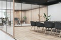 Contemporary wooden, concrete and glass meeting room interior with furniture and partitions. Workplace concept.