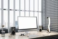 Contemporary wooden designer workspace with empty mock up computer screen, loud speakers and other items. Window frame with city Royalty Free Stock Photo