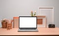 Contemporary workplace with laptop, picture frame and pencil holder. Royalty Free Stock Photo