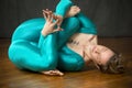 Young woman in blue body suit dancing in the studio. Royalty Free Stock Photo