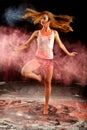 Contemporary dance girl spin pink blue powder Royalty Free Stock Photo