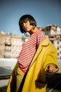 Contemptuous appealing female wearing stripped shirt and silver jewelry Royalty Free Stock Photo