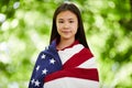 Content Asian girl covered with American flag