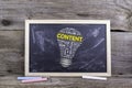 CONTENT bulb word cloud. Chalk board on a wooden table Royalty Free Stock Photo