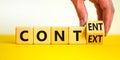 Content and context symbol. Businessman turns a wooden cube and changes the word context to content. Beautiful yellow table, white Royalty Free Stock Photo