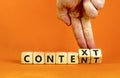 Content and context symbol. Businessman turns wooden cubes and changes the word context to content. Beautiful orange table, orange Royalty Free Stock Photo