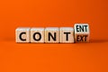 Content and context symbol. Turned a wooden cube and changed the word context to content. Beautiful orange table, orange