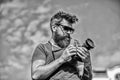 Content creator. Man bearded hipster photographer. Man shooting photos. Old but still good. Manual settings