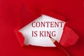 CONTENT IS KING text on the red torn paper with red pencil