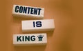 Content is king words on wooden blocks on dark grey background. Copywriting storytelling concept