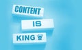 Content is king words on wooden blocks on dark grey background. Copywriting storytelling concept