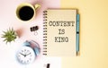Content is King work on white ring binder notebook with hand holding pencil on wood table,Digital Royalty Free Stock Photo