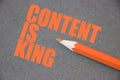 Content is king written on blackboard with orange crayon pencil. Search Engine Optimization concept Royalty Free Stock Photo