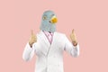 Satisfied man wearing suit and funny pigeon mask showing thumbs up with both hands Royalty Free Stock Photo