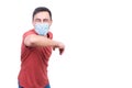 Content man in protective mask doing greeting gesture