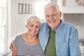 Content senior couple standing together at home in their kitchen Royalty Free Stock Photo