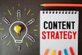 Content Strategy concept on notebook with many light bulbs Royalty Free Stock Photo