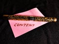 content text presented on pink colour paper slip with pen isolated Royalty Free Stock Photo