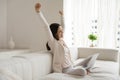 Content woman freelancer stretching arms in delight distracted from screen Royalty Free Stock Photo