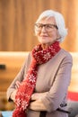 Content wrinkled lady in Christmas scarf