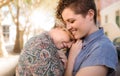 Smiling young lesbian couple sharing an affectionate moment together outside Royalty Free Stock Photo