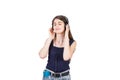 Contented girl listening relaxing music on her phone, keeps hand to headset and eyes closed isolated over white background