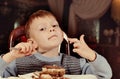 Contented little boy eating cake for dessert Royalty Free Stock Photo