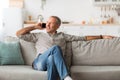 Contented Mature Man Talking On Cellphone Looking Aside At Home Royalty Free Stock Photo