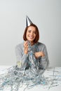 contented woman in party cap and