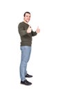 Contented young man, full length portrait, shows both thumbs up gesture, isolated on white background. Attractive casual guy, side