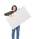 Contented young man holding a big blank banner for advertising pointing and showing with index finger. Happy guy with an empty Royalty Free Stock Photo