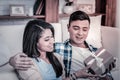 Contented young people relaxing at home together