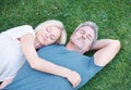 Contentment in a meadow. A mature couple sleeping on the grass together. Royalty Free Stock Photo