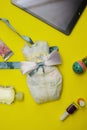 Contents of a woman`s bag on yellow background. Royalty Free Stock Photo
