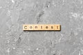 Contest word written on wood block. Contest text on cement table for your desing, Top view concept Royalty Free Stock Photo