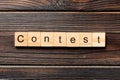 Contest word written on wood block. Contest text on wooden table for your desing, Top view concept Royalty Free Stock Photo