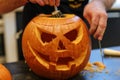 contestant carving a pumpkin with a dramatic facial expression Royalty Free Stock Photo