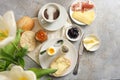 Continental breakfast with bread roll, cooked egg, jam, cheese, ham and coffee, light rustic background with copy space, high Royalty Free Stock Photo