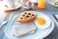 Continental breakfast contain waffle, egg, ham cup of coffee and juice. Royalty Free Stock Photo