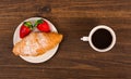 Continental breakfast with croissant, coffees and fresh strawberries. Royalty Free Stock Photo