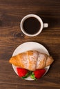 Continental breakfast with croissant, coffees and fresh strawberries. Royalty Free Stock Photo